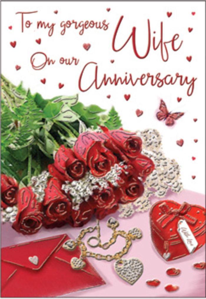 A tender, thoughtfully arranged anniversary card tableau is presented as if resting on a polished surface in a Swiss Cottage home, catching the last of the afternoon light. At the centre, a handful of red roses sits proudly, their blossoms rich and plush, with petals that layer tightly in the middle and soften outwards into gentle, rounded edges. The colour runs deep, from velvety crimson at the base to slightly brighter highlights on the outer curves, like the changing tones of the sky above the local streets at sunset. Surrounding the roses, glossy green leaves provide a vivid contrast, their natural shapes bending and overlapping, giving the bouquet a sense of fullness and life. Nearby, an elegant envelope lies positioned at a slight angle, its neutral tone and smooth texture evoking the promise of handwritten words and shared memories. A heart-shaped box, perhaps filled with a sentimental token, and a subtle piece of jewellery rest close by, catching fleeting glimmers of light like tiny reflections from shop windows along Finchley Road. Scattered across the scene are small heart decorations and a delicately drawn butterfly, adding hints of whimsy and reminding the viewer of the lightness that often accompanies deep, enduring love. The card's calligraphic script curves gracefully across the design, harmonising with the organic lines of stems and petals. Soft, diffuse lighting gently illuminates the entire arrangement, enhancing every texture-the velvet of the roses, the cool smoothness of paper, the slight sheen of metal-without any harsh edges. Crafted with the trained eye of a florist attuned to Swiss Cottage's quiet romantic moments, the composition feels personal, reflective, and perfectly suited to mark another year of shared life and affection.